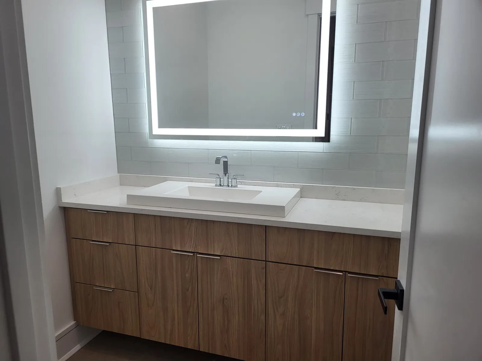 Floating vanity with an LED mirror in the same home