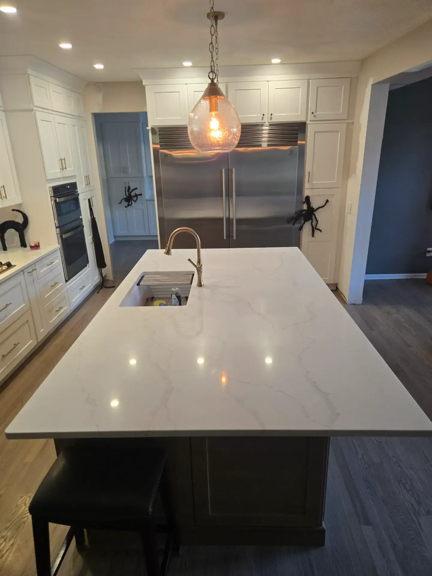 Large white island countertop with an undermount sink