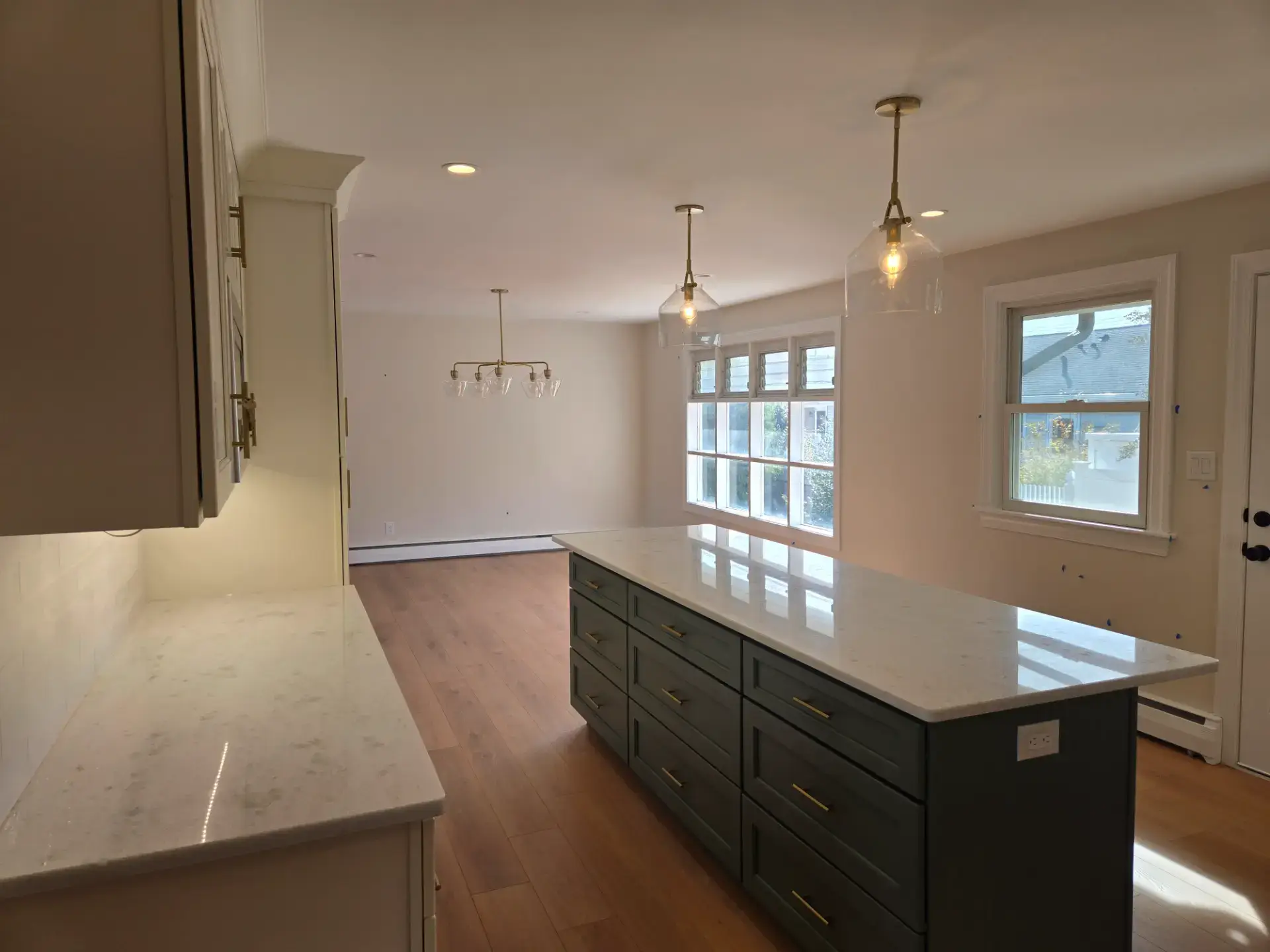 Open plan kitchen with a dark island facing the living space