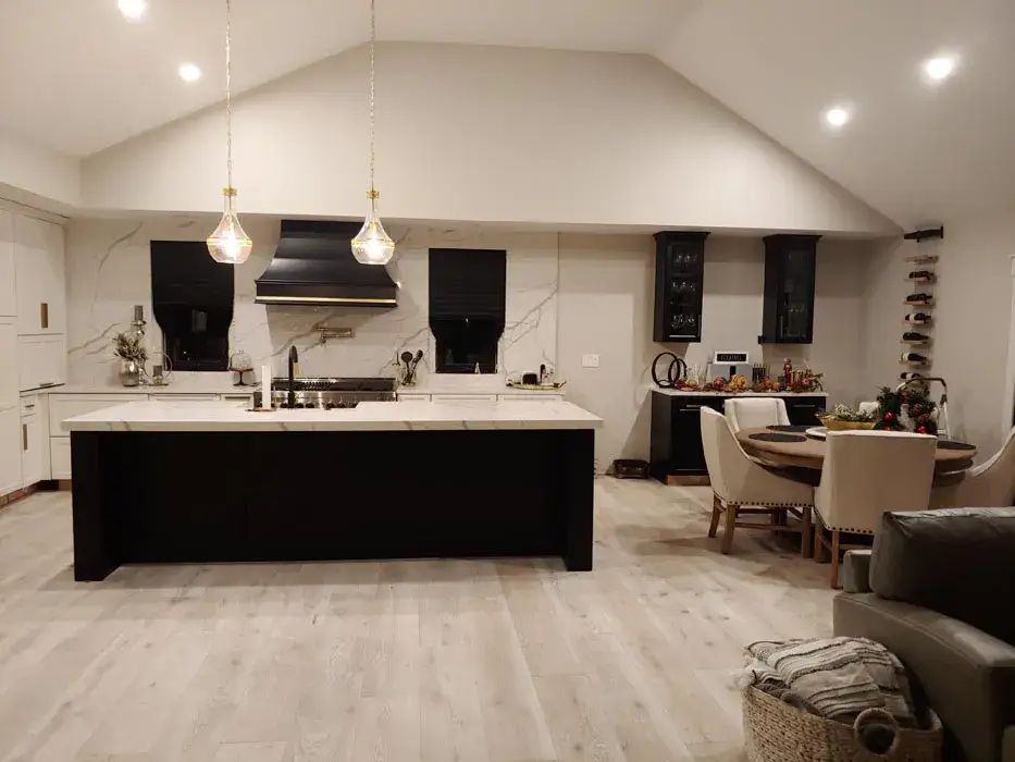 Dark island in a kitchen with a vaulted ceiling