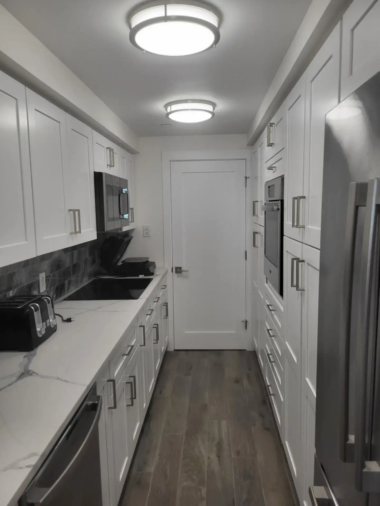 Compact galley kitchen in white shaker
