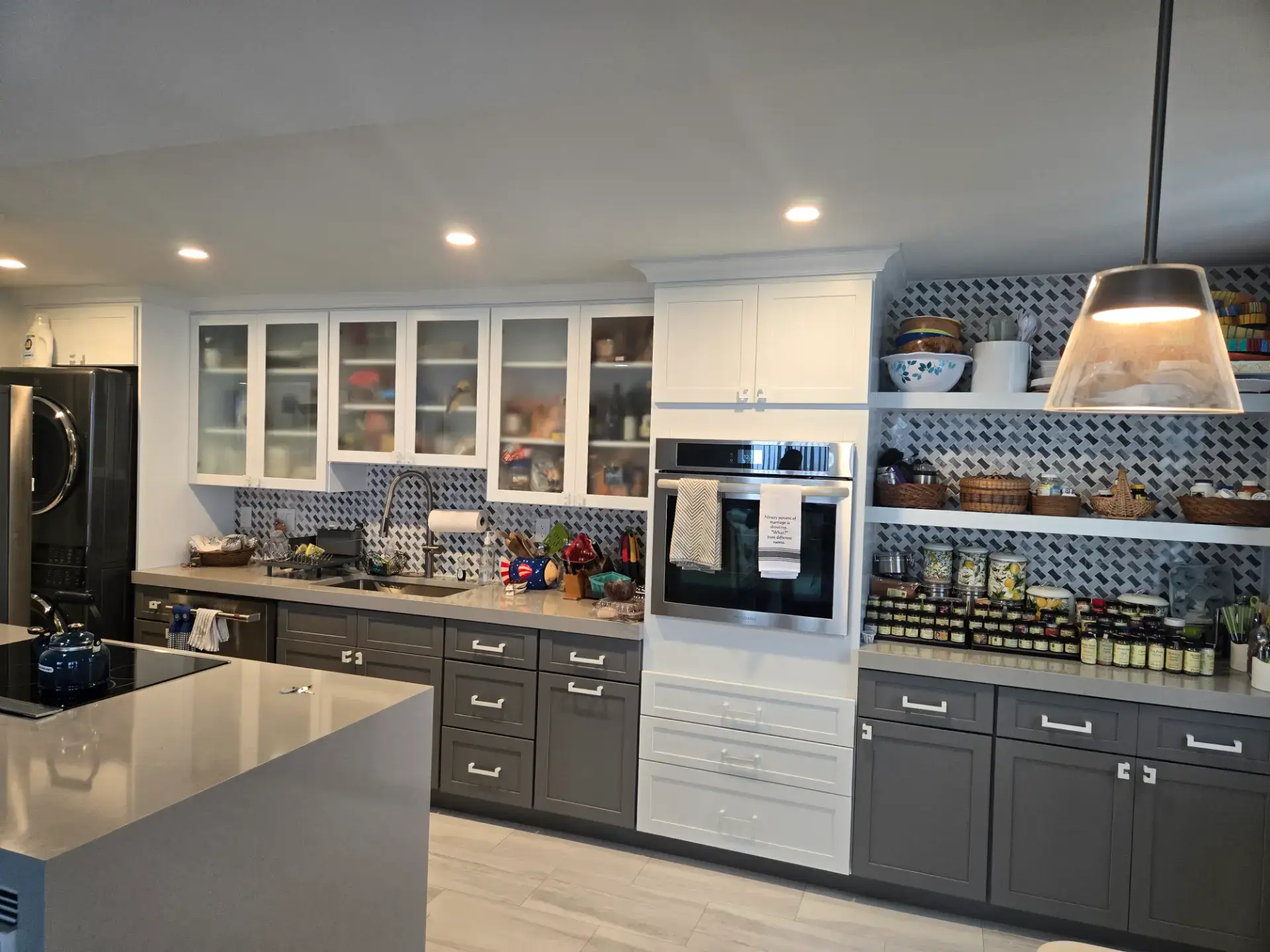 Grey kitchen with glass front upper cabinets and open shelving