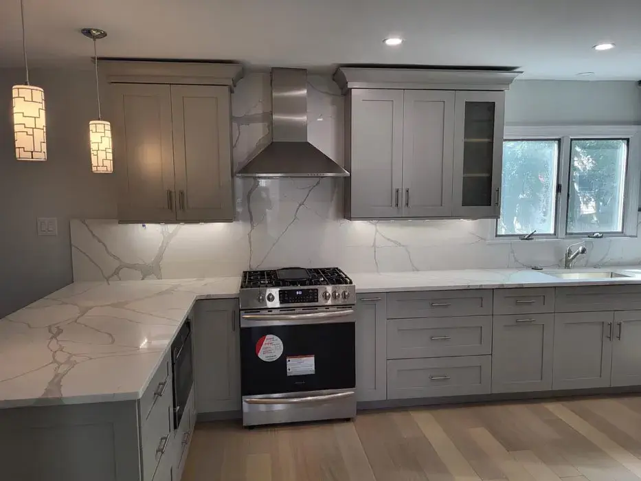 Grey shaker cabinetry with a slide in range