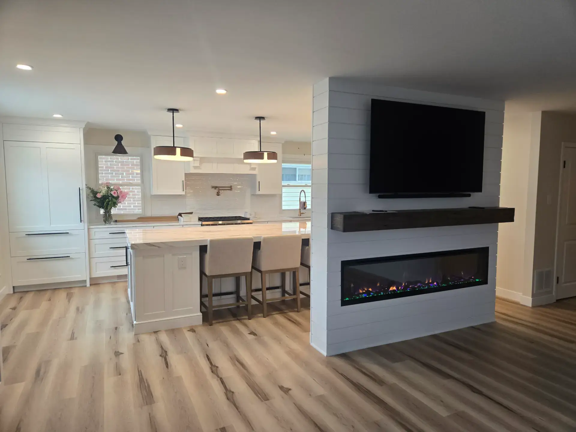 Kitchen island in an open room with a fireplace