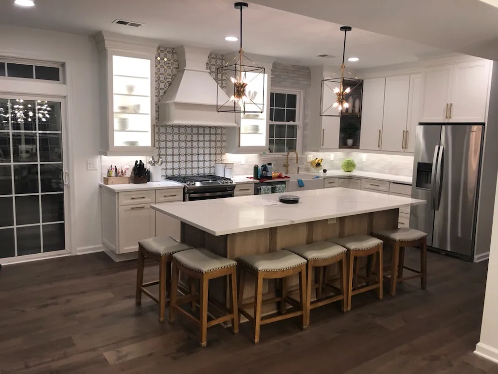 White shaker kitchen with a quartz island and seating