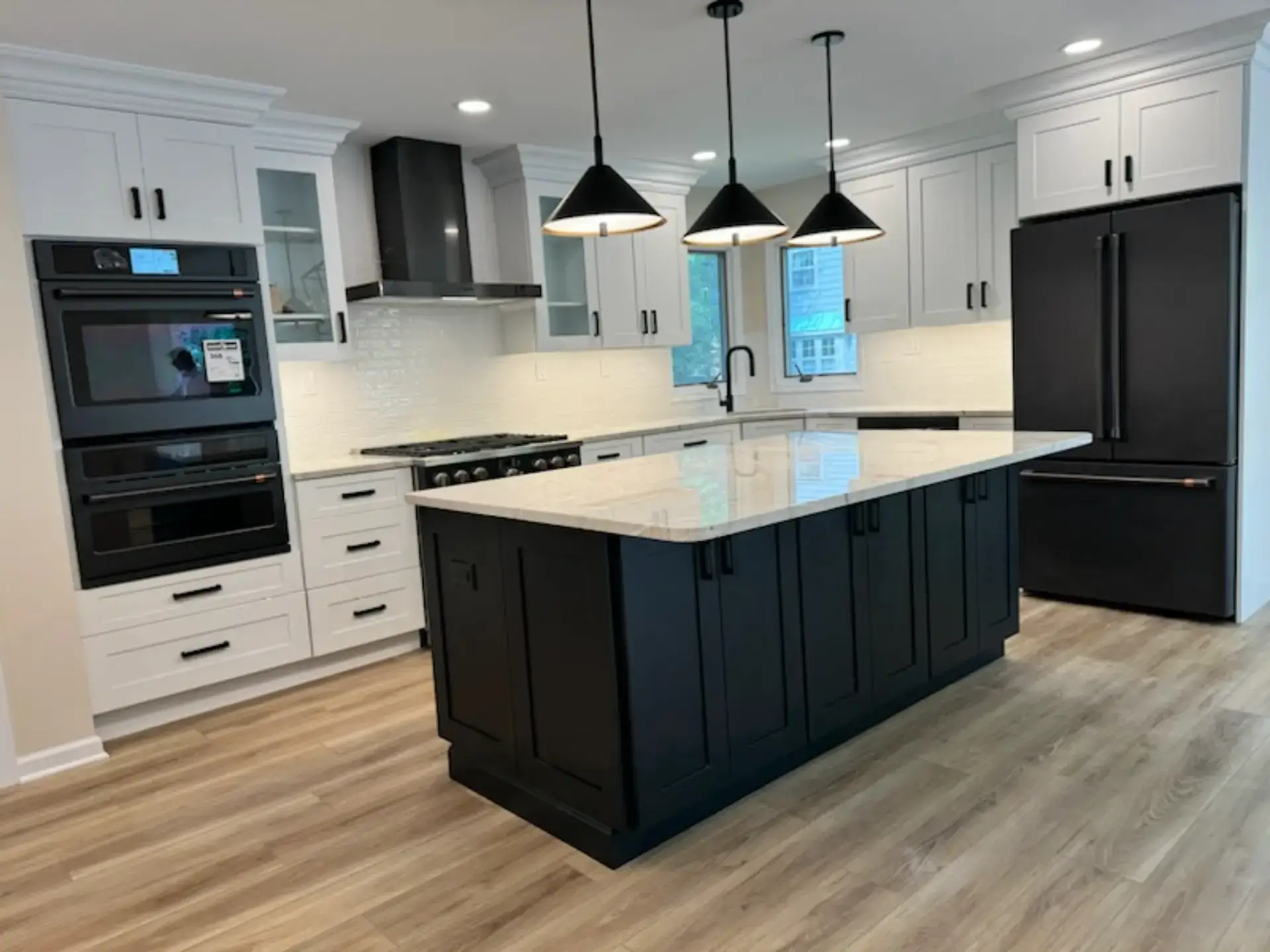 Navy kitchen island under pendant lighting