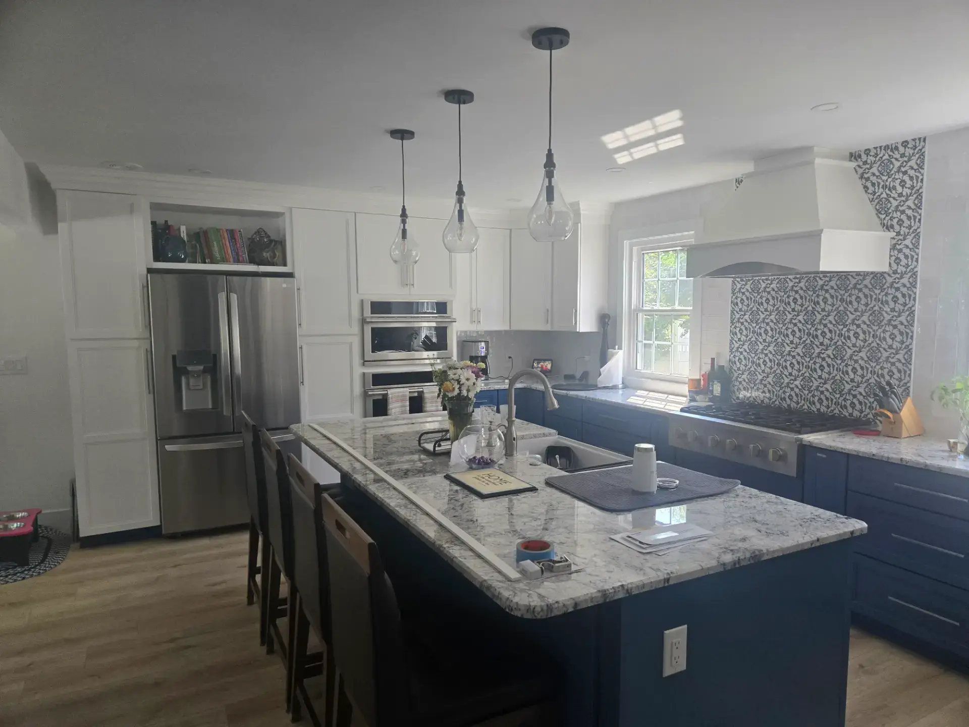 Navy island paired with white upper cabinets
