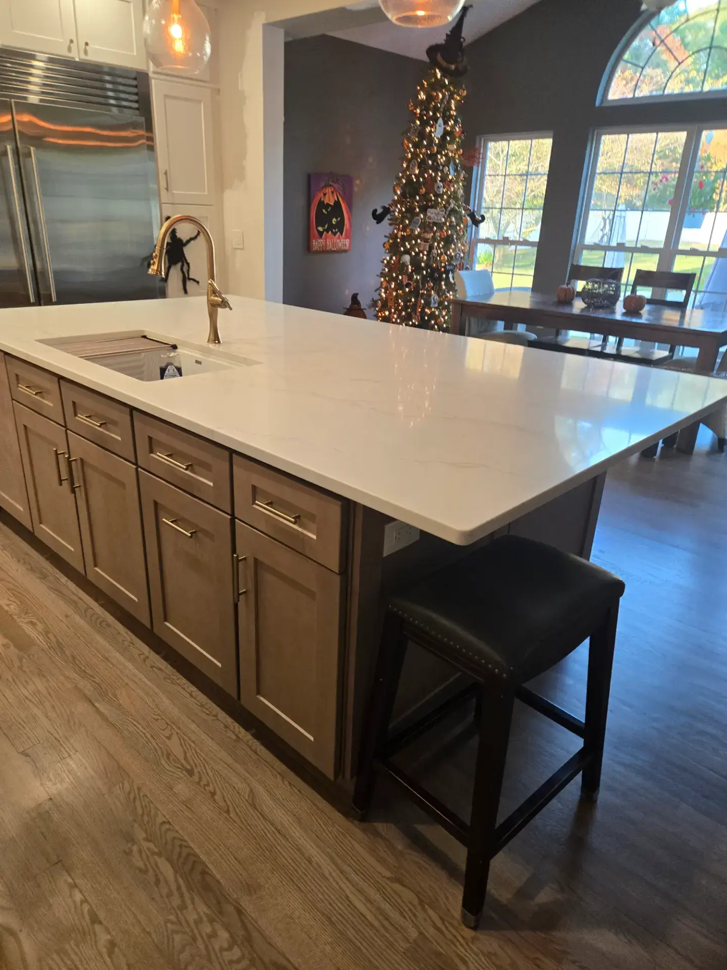 Stained wood island with a marble countertop