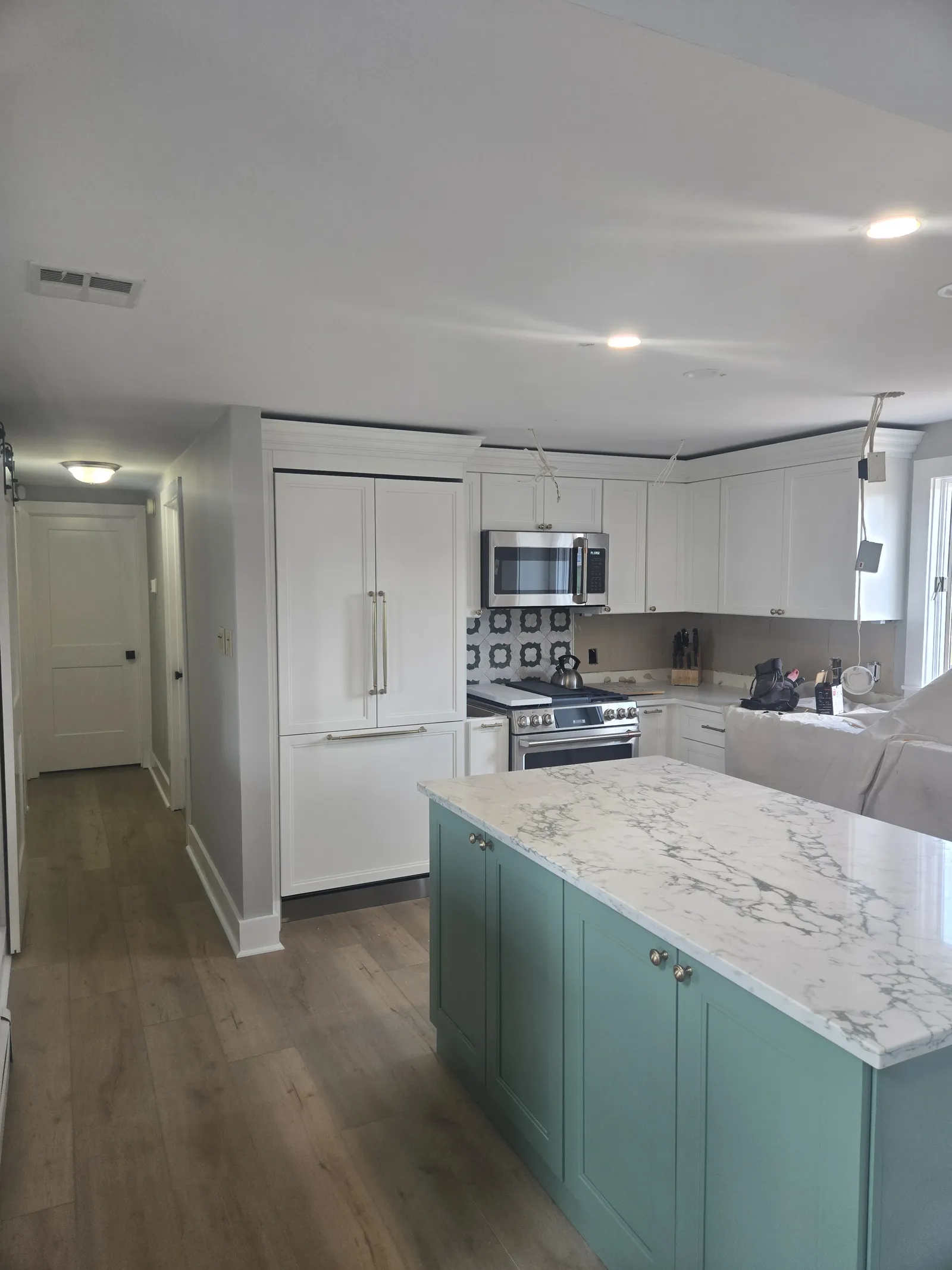 White kitchen with a teal blue island