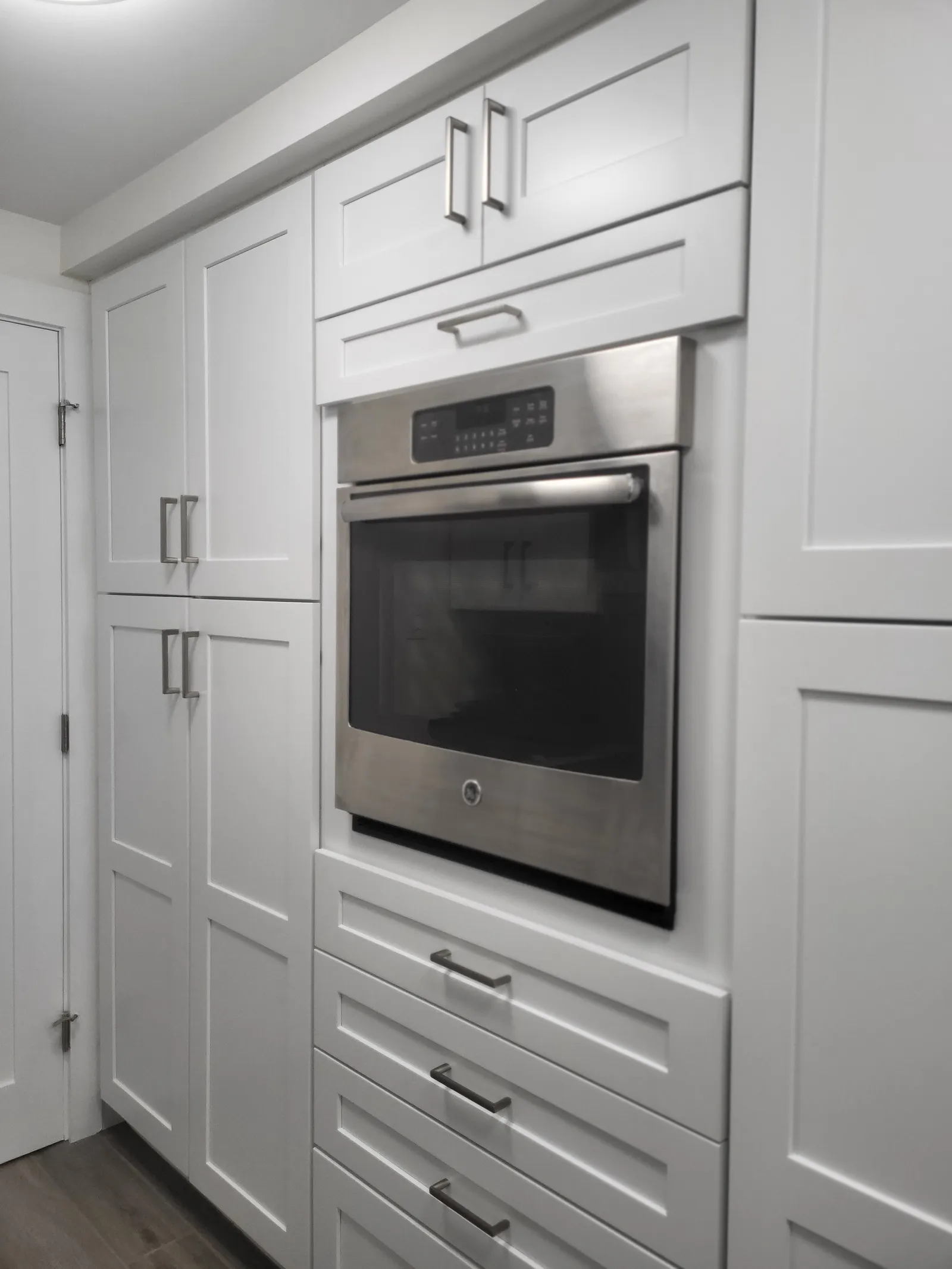 Wall oven cabinetry in the same kitchen