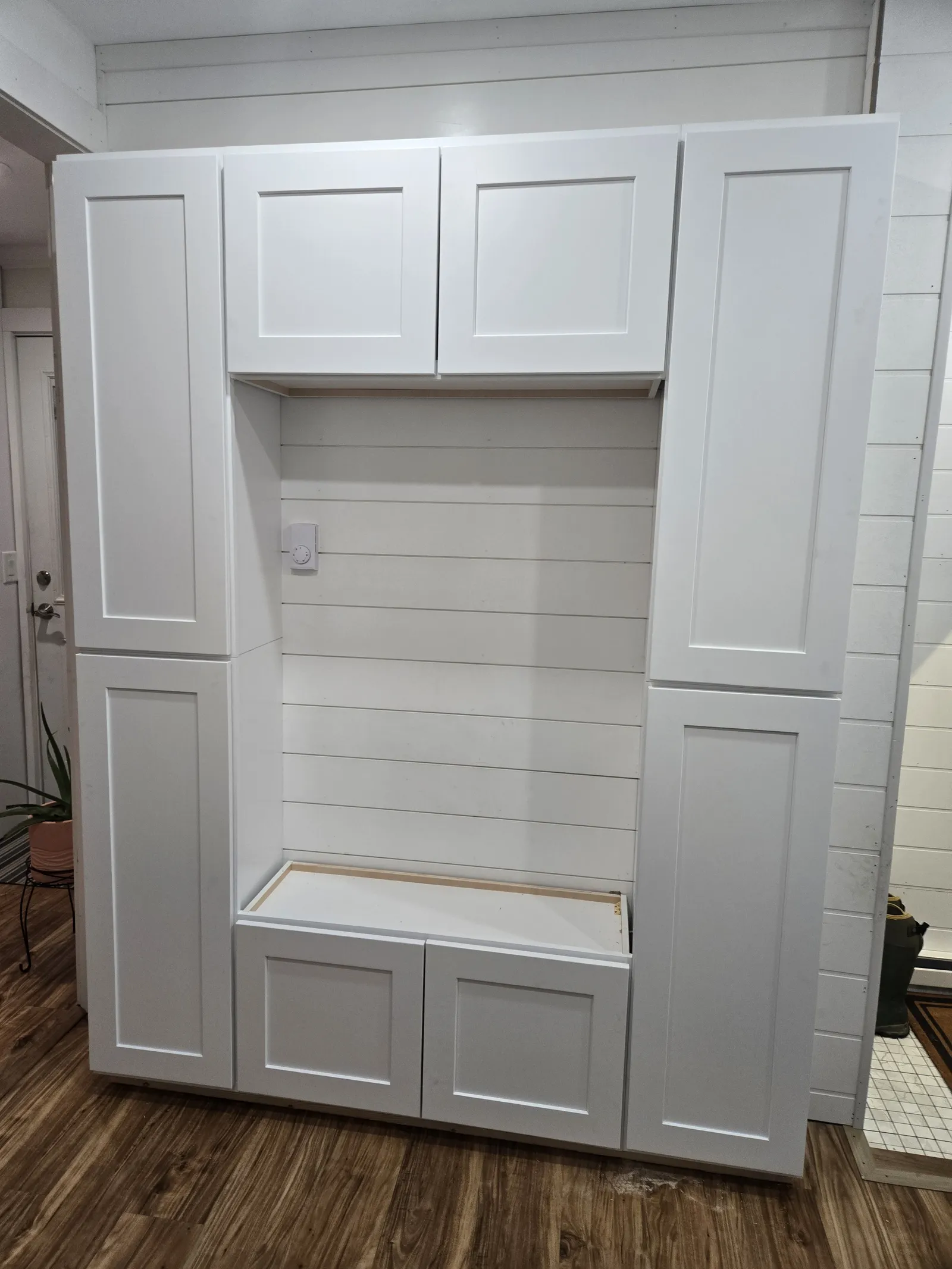 Mudroom bench with shiplap back and white cabinetry