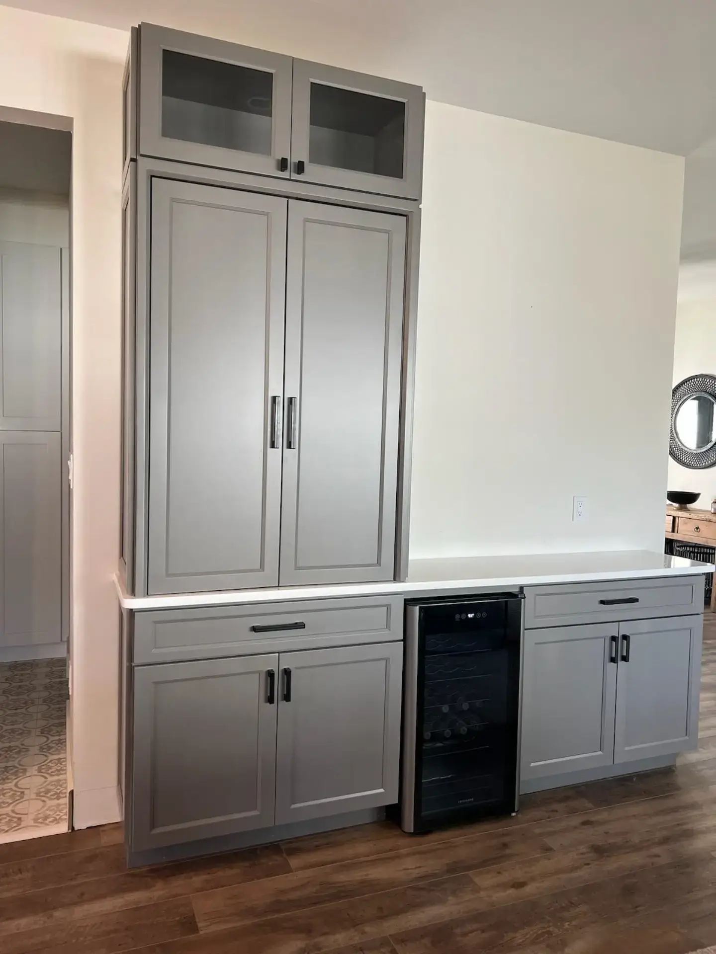 Showroom display with tall cabinetry and a beverage center
